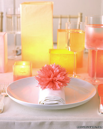 Paper dahlia napkin rings in citrus shades adorn each place setting